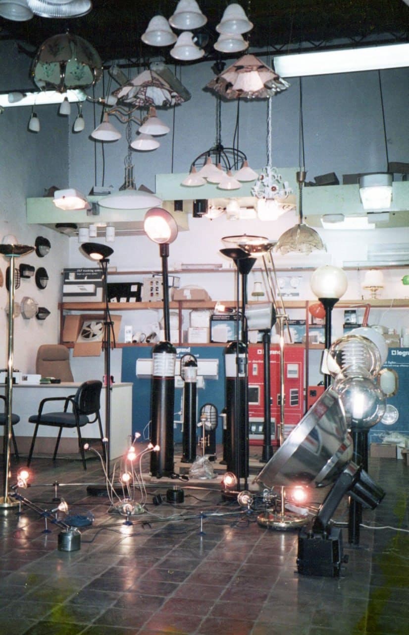 Pendants and shades hung in rows over the shop floor, lamps burning below them