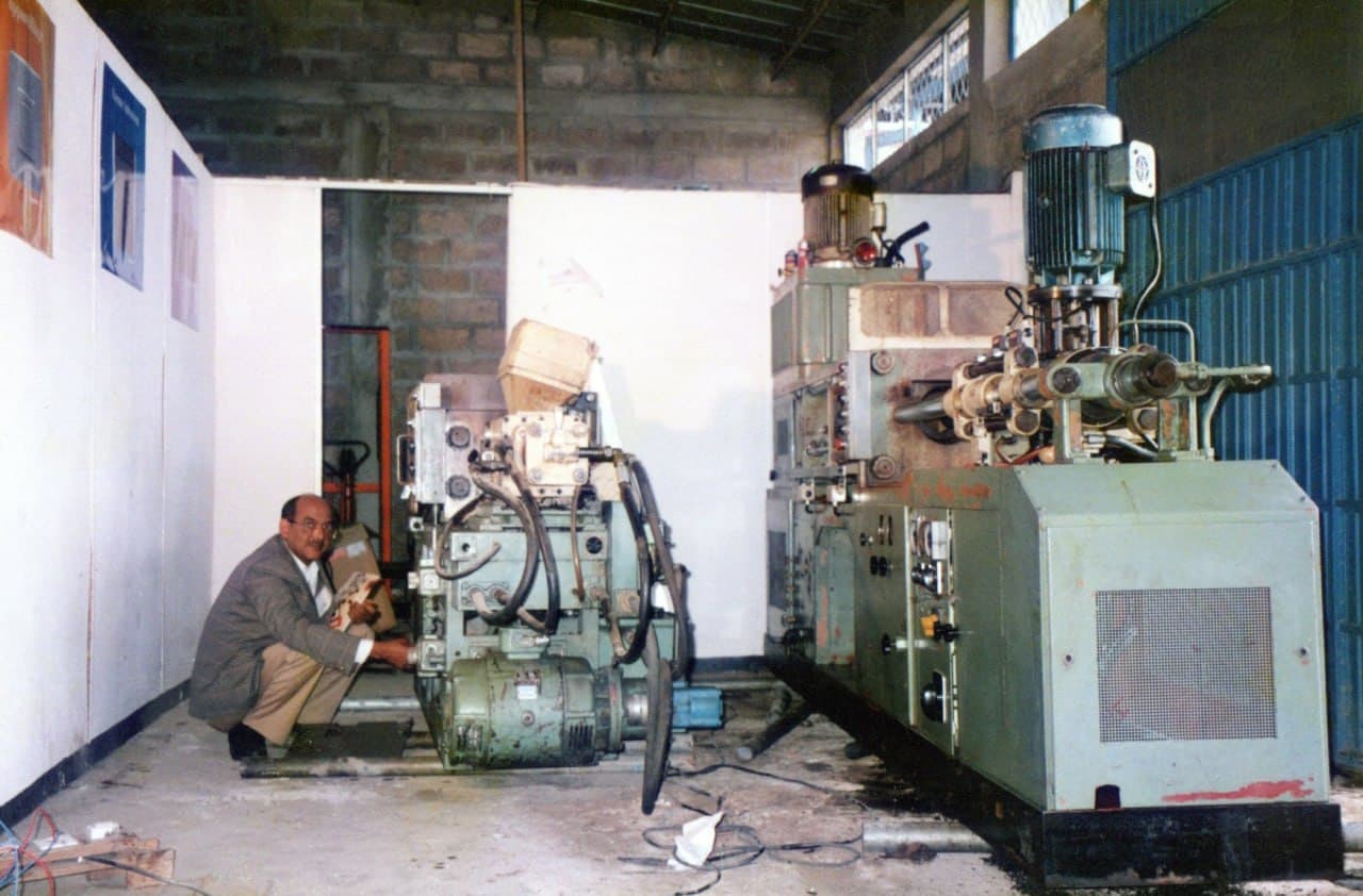 An engineer at work beside machinery in the Dama workshop
